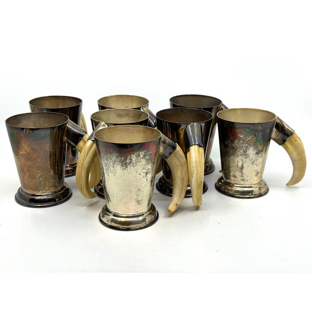 A wonderful set of 8 P.H. Vogel silver plate mugs with boar tusk handles. These wonderful pieces were found in a local...