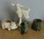 Charming assortment of four vintage animal form planters. Features a lamb, pig, frog and elephant with leaves. Measuring...