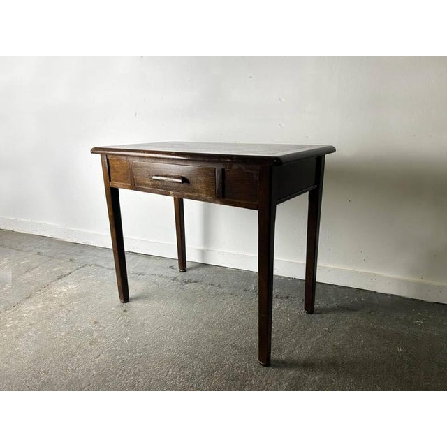 A compact, well-made single drawer desk or writing table by Abbess Office Equipment in dark stained oak. Circa 1950s–60s....