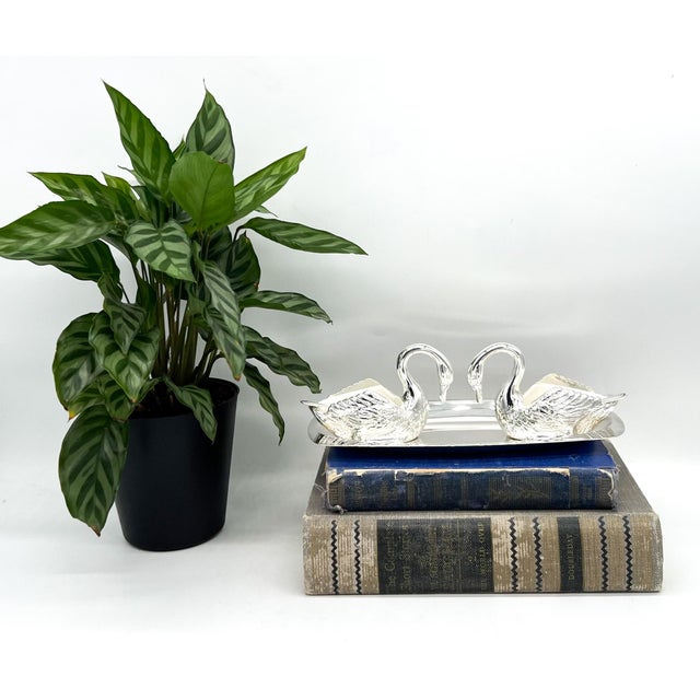Charming and exquisitely detailed, this mirrored pair of Venetian Italian silver-plated swan salt cellars brings instant...