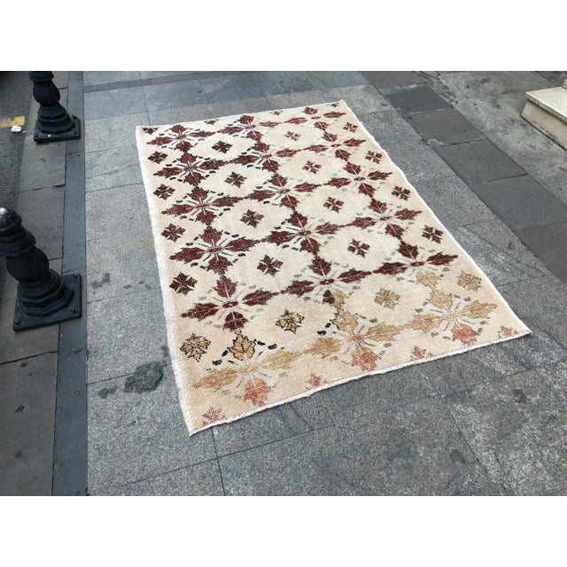 This is a vintage Turkish Oushak rug from the 1960s. The piece was hand-knotted.