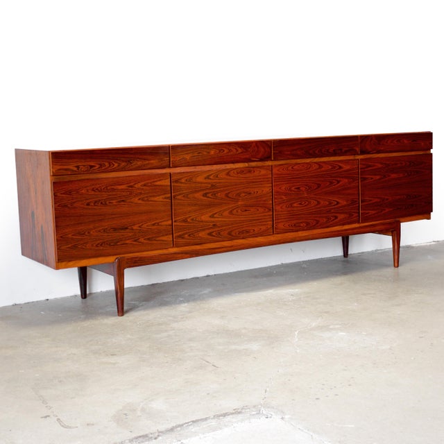 Dimensions: 90 9/16" L x 19 1/2" D x 30 1/8" H Origin: Faarup, Denmark Designer: Ib Kofod-Larsen Manufacturer: Faarup...