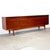 Dimensions: 90 9/16" L x 19 1/2" D x 30 1/8" H Origin: Faarup, Denmark Designer: Ib Kofod-Larsen Manufacturer: Faarup...