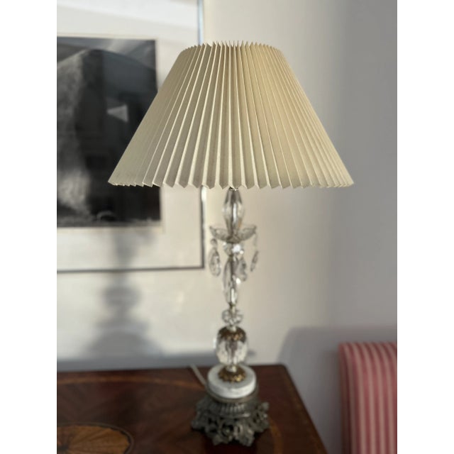 This lovely table lamp is an elegant, graceful addition to any room. The crystal base is comprised of a lovely decorative...