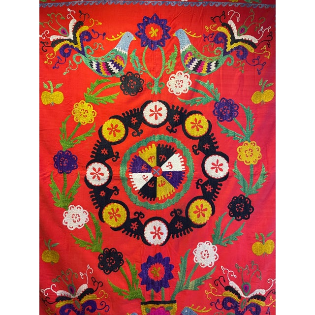 This is a beautifully hand embroidered Suzani in the most wonderful colors. It looks stunning on a wall as shown, on a...