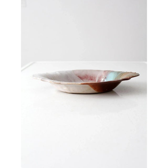 This is a vintage studio pottery bowl. Signed by the artist, the hand-crafted bowl reminisces with antique porcelain...
