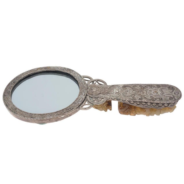 Vintage decorated silver toilet mirror with inclusions in jade shaped as dragons. China, beginnings of 20th century.