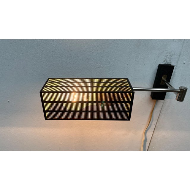 Mid century wall lamp from the german manufacturer bur leuchten. cubic shapes permeate this design, from the shade to the...