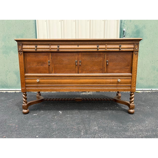 A beautiful and large Victorian style oak sideboard buffet from the early 1900s. Utilizing Quartersawn oak, this sideboard...