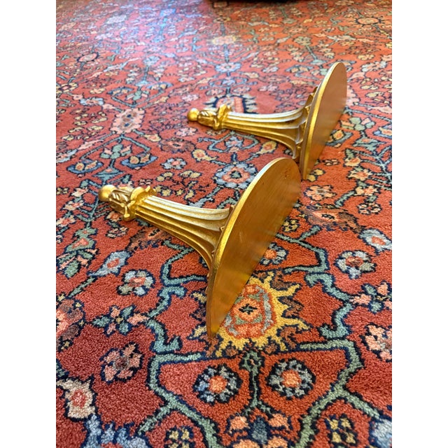 A striking pair of vintage Italian giltwood wall bracket shelves in the neoclassical style. These sculptural brackets...