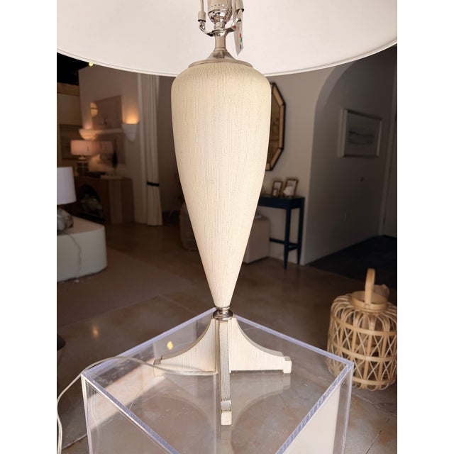 This contemporary transitional table lamp blends timeless elegance with clean, modern lines. Featuring nickel hardware and...