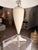 This contemporary transitional table lamp blends timeless elegance with clean, modern lines. Featuring nickel hardware and...