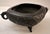 A small, deep-bellied bronze or vessel with a dense, all-over textured pattern of interlocking spirals and medallions,...