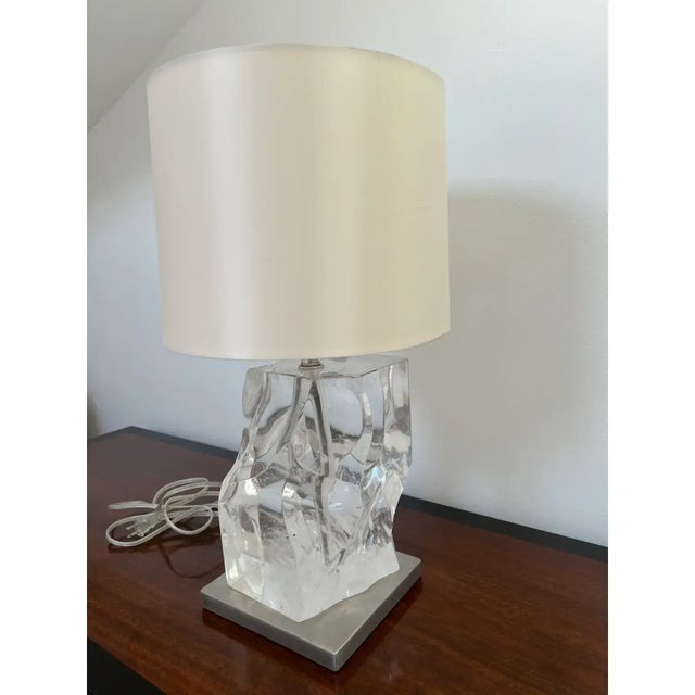 This is a natural polished quartz lamp by Jacques Garcia for Baker Furniture, it has a silver base with a switch on the...