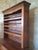 A superb, large, two-part sideboard in fruitwood, likely walnut or cherry, boasting a magnificent antique patina in warm...