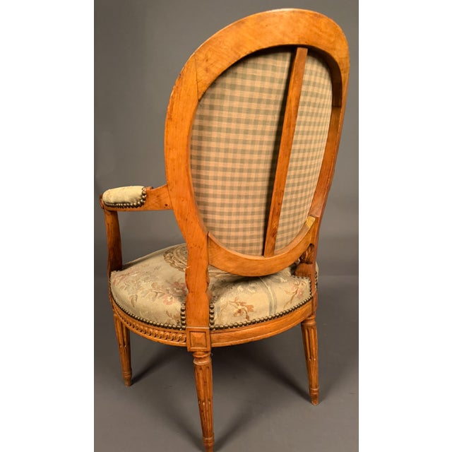 A beautiful antique French Louis XVI style bergère chair dating to circa 1870, featuring an exceptional Aubusson tapestry...
