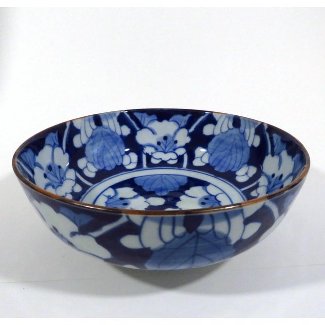 A vintage porcelain bowl with white blossoms against an ultramarine blue glaze. Purchased in Korea in the 1960s, and dated...