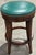 Two custom wood swivel bar stools in a walnut finish, designed for interior design firm, Katie Ridder Inc. Each seat...