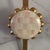 Mackenzie Childs wreath hangr. Pink and cream Courtly Check pattern medallion surrounded by gold-toned beading, mounted on...