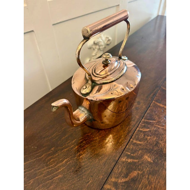 A charming hand-hammered copper kettle with a warm natural patina and a beautifully shaped spout. The body shows the...