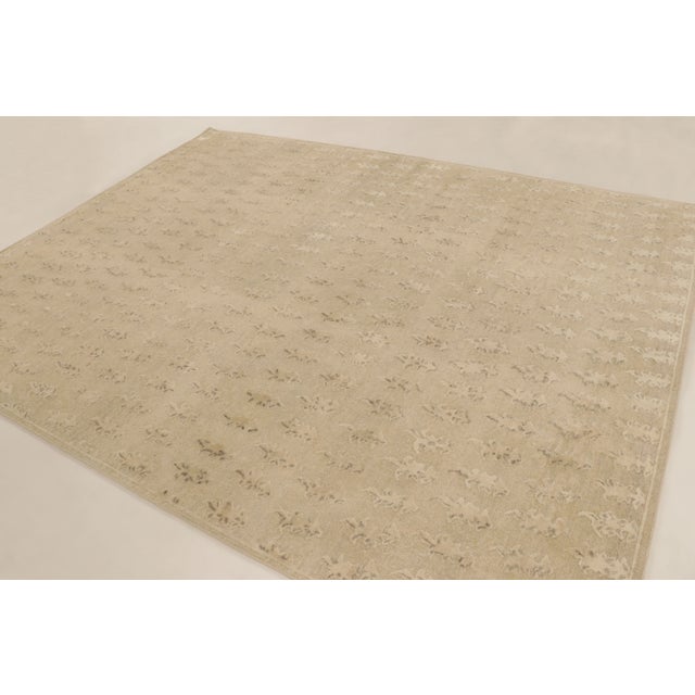 Hand-knotted in natural silk, this 8x10 Block Print rug features an understated floral pattern in warm beige tones. The...