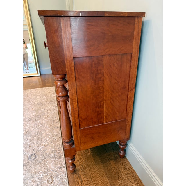 Beautiful Empire-style solid cherry wood chest of drawers featuring turned legs, wood pulls, and dovetail joints. Nice...