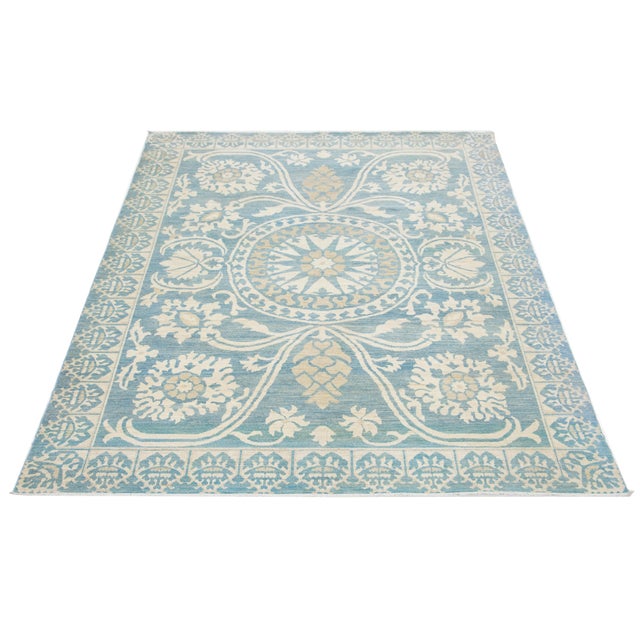 This modern Oushak-style wool rug combines contemporary design with traditional Oushak craftsmanship. Its blue background...