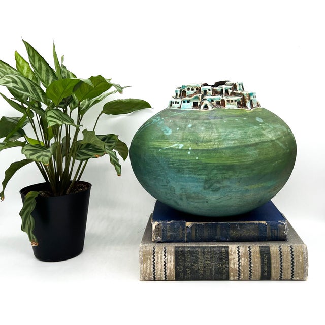 Captivating hand-thrown raku-fired vessel by Jeremy Diller, featuring a sculptural pueblo village rising from the rim. The...