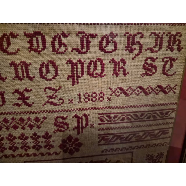 1888 Antique American redwork sampler. Professionally framed. Alphabet, numerals & multiple border designs. Signed S.P....