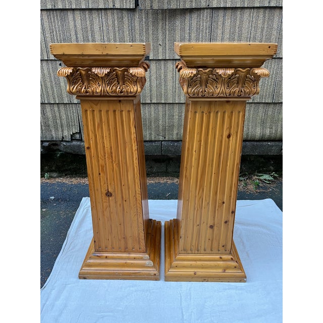 A matching pair of solid American pine pedestals featuring interior storage with hinged doors. Each pedestal features four...