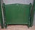 Directoire-style bed in green-painted wood. Composed of a headboard and footboard framed by turned uprights ending in...