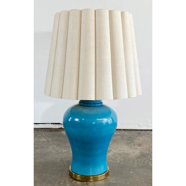 Vintage Mid Century Modern turquoise ginger jar table lamp with scalloped shade. Base rimmed with brass. Measure to top of...