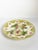 French pottery bowl dating from the 1960s, decorated with a colorful fruit and floral motif. The center features raised...