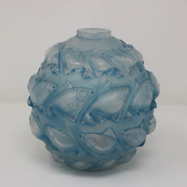 Rene Lalique Opalescent Glass with blue staining, 'Camaret' Vase. This pattern features four rows of fish molded in...