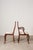 This set of eight 1930s walnut Queen Anne style dining chairs features cabriole legs with pad feet and turned stretchers....