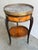 Louis XVI Style Mahogany and Marble Top Bouillotte Table, 19th Century. The circular gray variegated marble top within a...