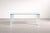 An elegant tempered glass table with a minimalist design, featuring clean lines and right angles with steel inserts. It...