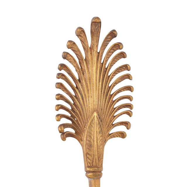 This beautiful set of two-tone bronze sconces are created from an arrow form decorated with central medallion with a face...