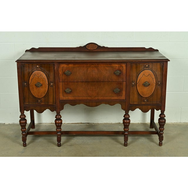 A beautiful antique English Jacobean style sideboard buffet or credenza In the manner of Berkey & Gay USA, Circa 1920s...