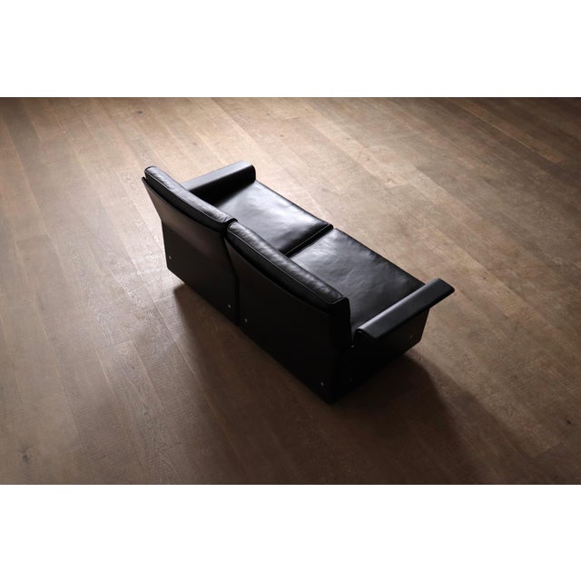 Iconic model 620 two seater sofa in black leather with black outer shell by dieter rams for vitsoe, germany 1980s. the...