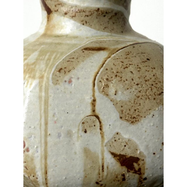 Made by Japanese ceramic artist Makoto Yabe (1947-2005), this stoneware vase features a globular body supported by a round...