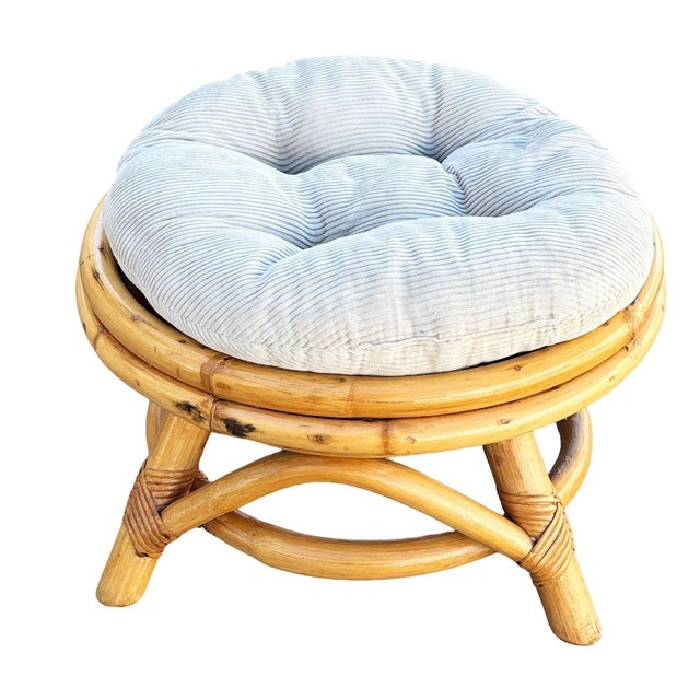 This beautifully restored coastal rattan round ottoman featuring a sturdy hand-wrapped rattan frame and a comfortable...
