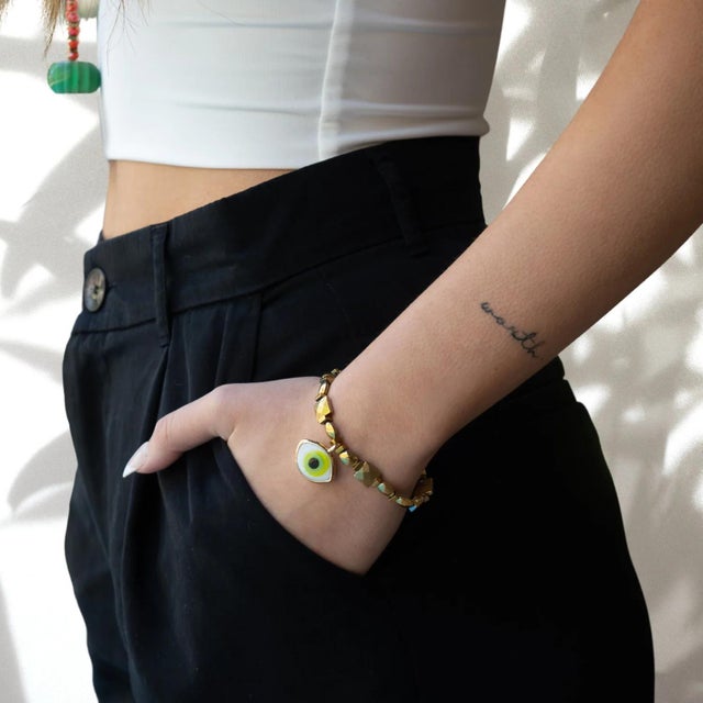 The Vitality Green Evil Eye Gold Hematite Stone Bracelet is a stunning piece of handmade jewelry that combines style and...