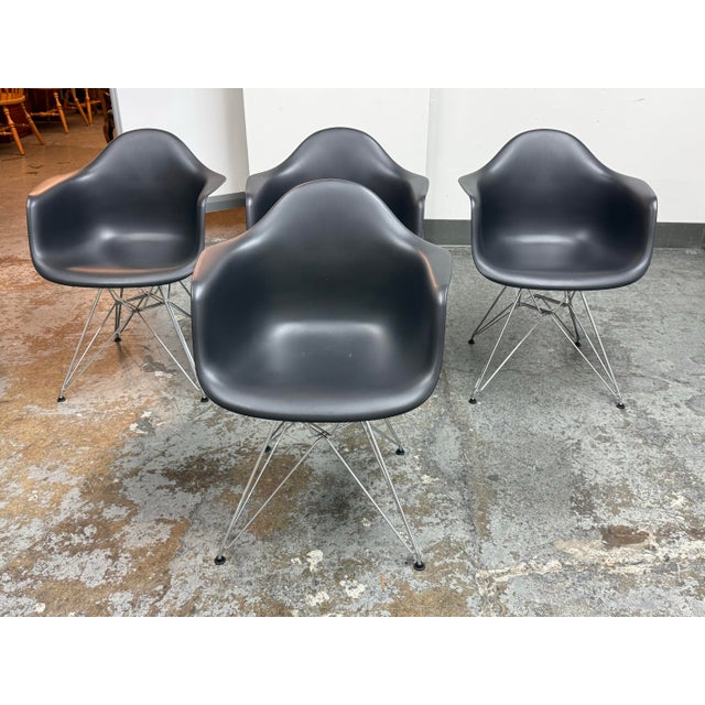 Design Plus Gallery presents a set of four Eames Plastic Armchair DAR chairs designed by Charles and Ray Eames for Vitra....