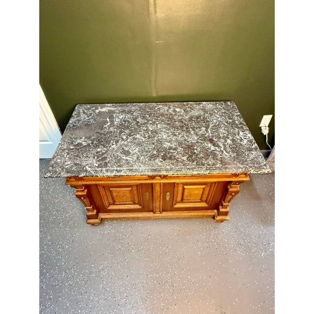 This is a gorgeous early 19th century French walnut marble top sideboard. It features beautiful walnut, impeccable...