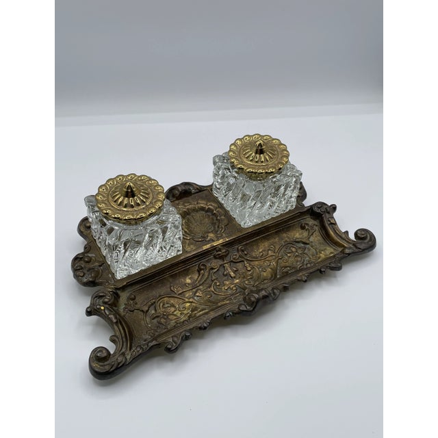 This charming late 19th to early 20th century double inkwell features two heavy pressed glass bottles with decorative...