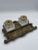 This charming late 19th to early 20th century double inkwell features two heavy pressed glass bottles with decorative...