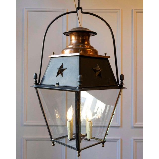 A striking 20th-century French hanging lantern crafted in copper and iron, combining traditional craftsmanship with a...