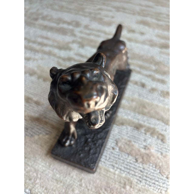 A Bronze Tiger mounted on a plinth base, unsigned, mouth agape and curled tail, nicely detailed with a mellow patina. A...