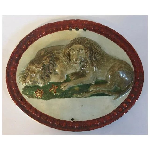 Antique early 19th century English George III pearlware Prattware oval wall plaque of two recumbent lions, circa 1800....